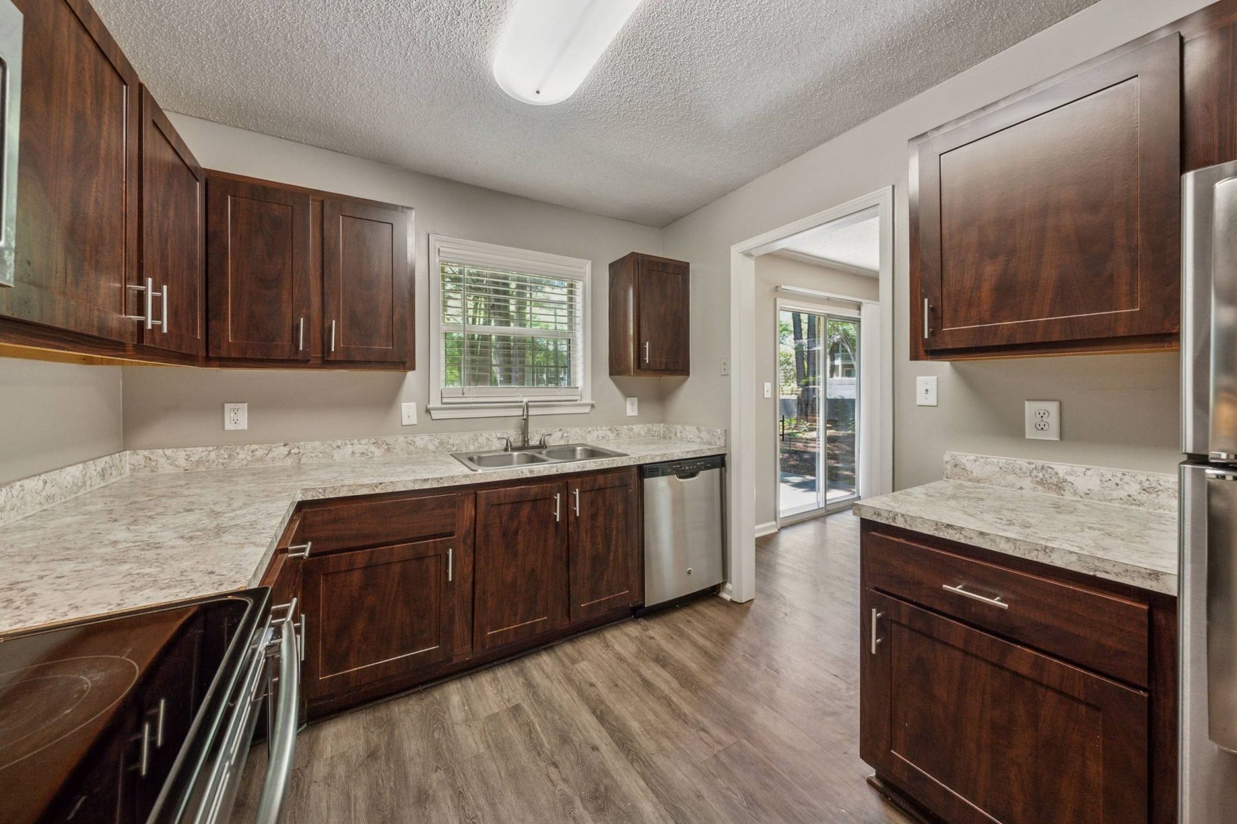 Luxury apartment kitchen with stainless steel appliances, granite countertops, and lots of storage space